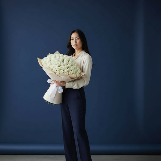 Woman holding a large bouquet of white flowers against a dark blue background