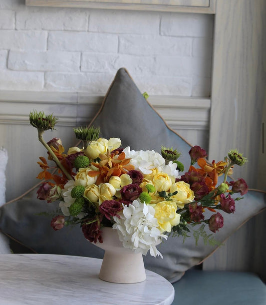 Floral arrangement in a white vase