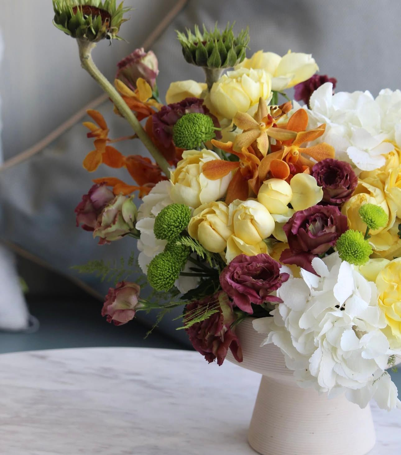 Bouquet of flowers on a white pedestal 