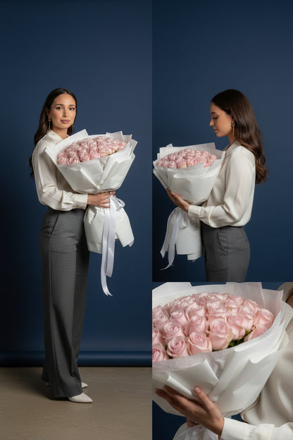 Woman holding a large bouquet of pink roses against a blue background