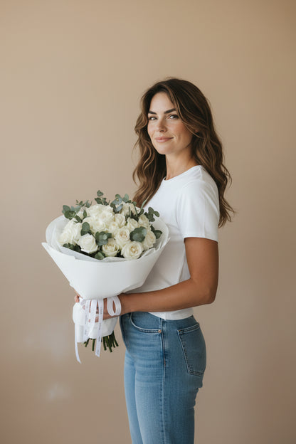 Woman holding a bouquet of flowers against a beige background