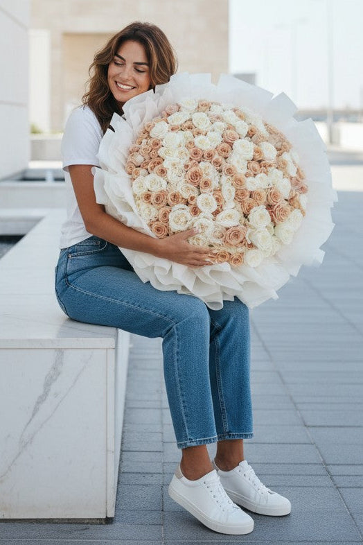 Woman holding a large bouquet of flowers outdoors