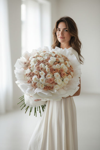 Woman holding a large bouquet of flowers in a softly lit room